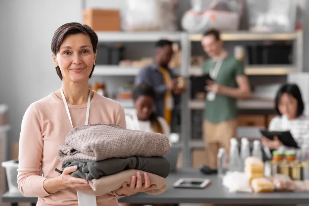 volunteer-selecting-organizing-clothes-donations-charity-1024x683